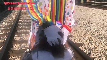 Pervert in a sleeper clown costume fucks a nipple's throat